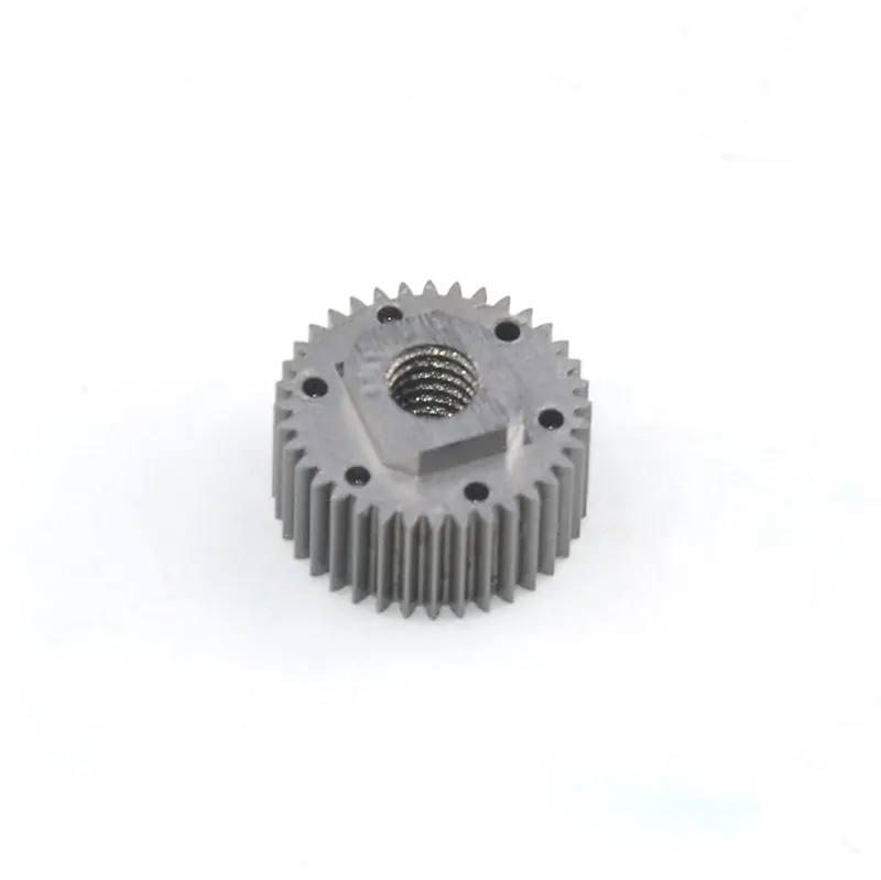 Small round machined metal gear with external teeth, a threaded center hole and smaller face holes